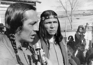 07 Mar 1973, Wounded Knee, South Dakota, USA --- Two leaders of the American Indian Movement Russell Means and Dennis Banks appear grim after meeting  with all the Indians at Wounded Knee, South Dakota, on the Pine Ridge Reservation.  Government officials proposed that the Indians leave Wounded Knee peaceably and have given the Indians until 6pm March 8th, to do so. --- Image by © Bettmann/Corbis